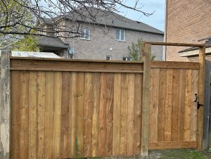 Wooden privacy fence with a gate in a residential neighborhood - Greater Toronto Area